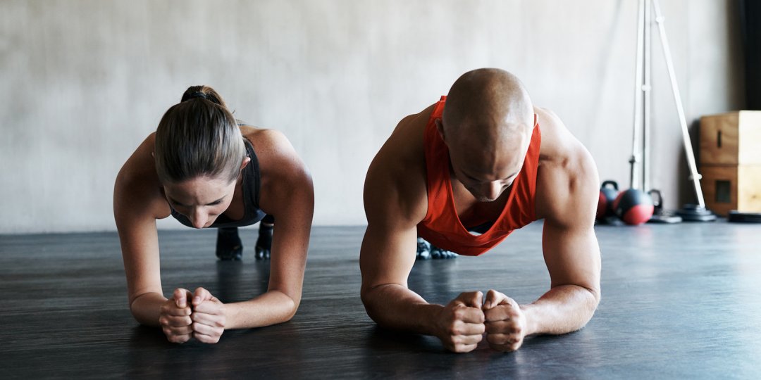 Two people doing plank